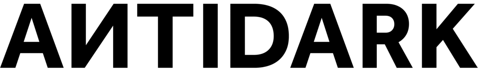 ANTIDARK" logo i fed, sort skrift.